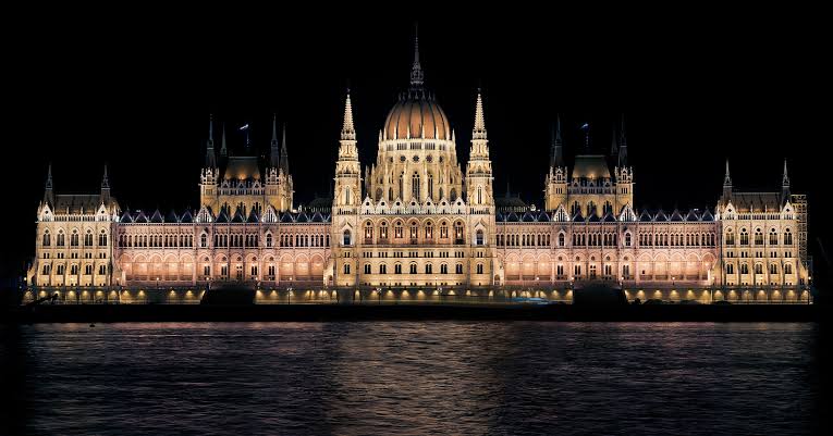 A view of the Hungarian Parliament Building at night in Budapest