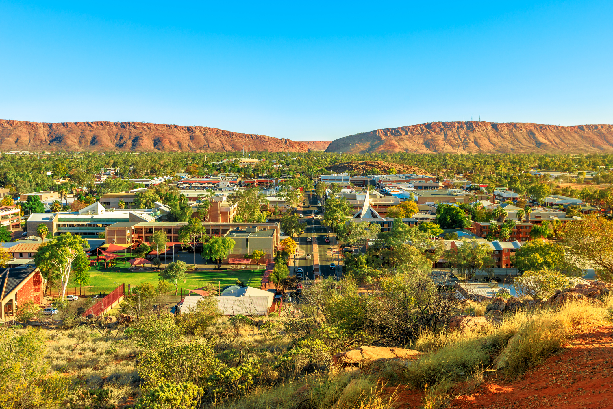 Aerial view of Alice Springs skyline in Australia from Anzac Hill Memorial lookout with main buildings of Alice Springs city downtown. Red Centre desert with Macdonnell ranges